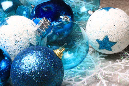 Blue christmas balls on a table with fir branches and snowflakesの写真素材