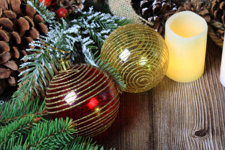 Christmas balls on a table with fir branches and pine conesの写真素材