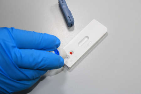 Health hand performing a covid-19 antigen test