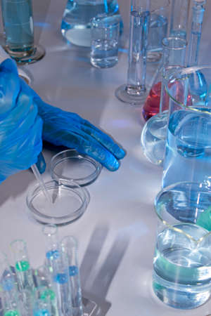 Hand of a scientist taking samples with a pipette