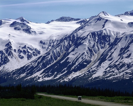 Mountain under snow and highwayの写真素材