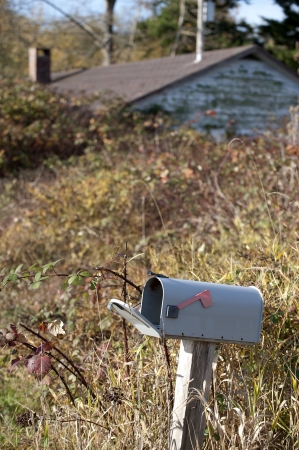 Mail box - country letter box with old abandoned houseの写真素材