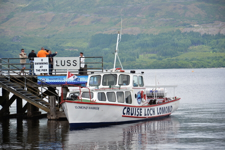 Luss, United Kingdom - July 15, 2013  Boat cruise on Loch Lomond - the largest inland stretch of water in Great Britain on 15 July 2013 in Luss, Scotland, UK のeditorial素材