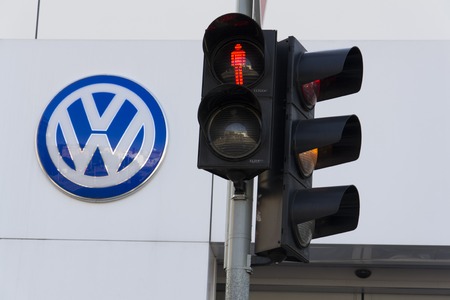 PRAGUE, CZECH REPUBLIC - OCTOBER 1: Red colour on traffic light with Volkswagen car maker logo on a building of czech dealership on October 1, 2015 in Prague, Czech republic. Great emission scandal raises around number of Volkswagen Group cars with the EAのeditorial素材