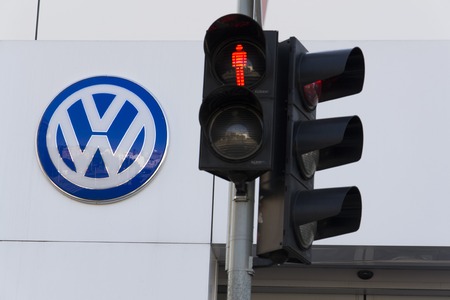 PRAGUE, CZECH REPUBLIC - OCTOBER 1: Red colour on traffic light with Volkswagen car maker logo on a building of czech dealership on October 1, 2015 in Prague, Czech republic. Great emission scandal raises around number of Volkswagen Group cars with the EAのeditorial素材