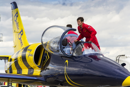 HRADEC KRALOVE, CZECH REPUBLIC - SEPTEMBER 5: Crew of the Baltic Bees Jet Team with L-39 Albatros planes standing on runway at Czech international air festival on September 5, 2015 in Hradec Kralove, Czech republic.のeditorial素材