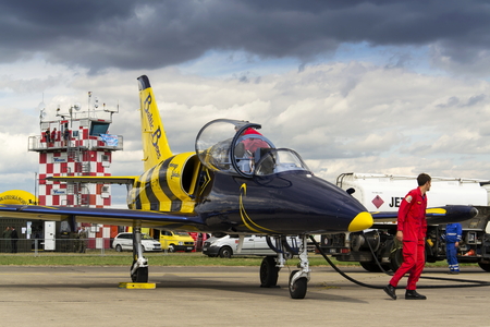 HRADEC KRALOVE, CZECH REPUBLIC - SEPTEMBER 5: Crew of the Baltic Bees Jet Team with L-39 Albatros planes standing on runway at Czech international air festival on September 5, 2015 in Hradec Kralove, Czech republic.のeditorial素材