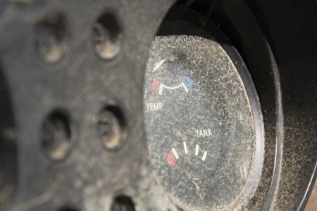 Rusty fuel gauge on vintage car control panel on sunny dayの写真素材