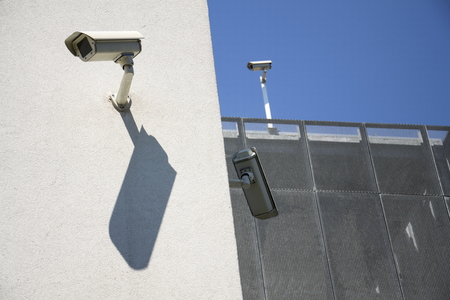 White security cameras on white wallの写真素材