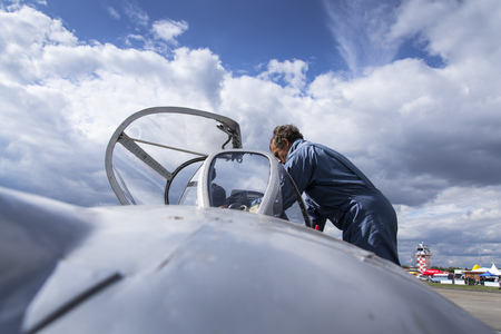 HRADEC KRALOVE, CZECH REPUBLIC - SEPTEMBER 5: Pilot of jet fighter aircraft Mikoyan-Gurevich MiG-15 developed for the Soviet Union standing on runway on September 5, 2015 in Hradec Kralove, Czech republic.のeditorial素材