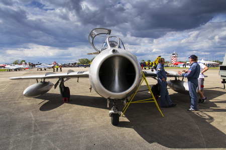 HRADEC KRALOVE, CZECH REPUBLIC - SEPTEMBER 5: Pilot of jet fighter aircraft Mikoyan-Gurevich MiG-15 developed for the Soviet Union standing on runway on September 5, 2015 in Hradec Kralove, Czech republic.のeditorial素材