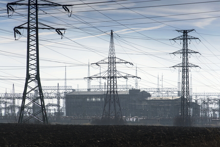 Electricity pylons with distribution power station blue cloudy skyの写真素材