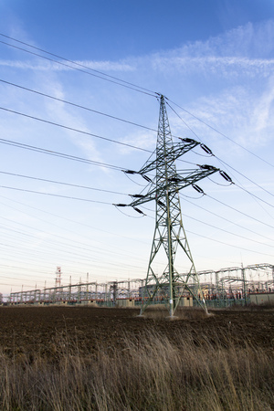 Electricity pylon with dramatic cloudy sky vertical photoの写真素材