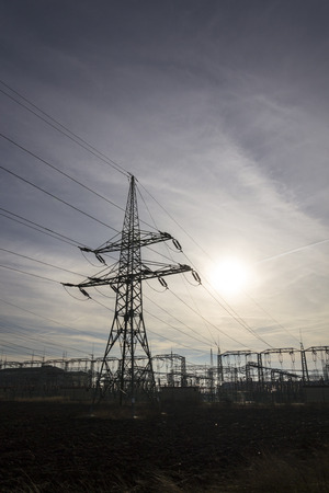 Electricity pylon with dramatic cloudy sky vertical photoの写真素材