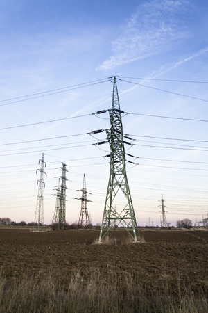 Electricity pylon with dramatic cloudy sky vertical photoの写真素材