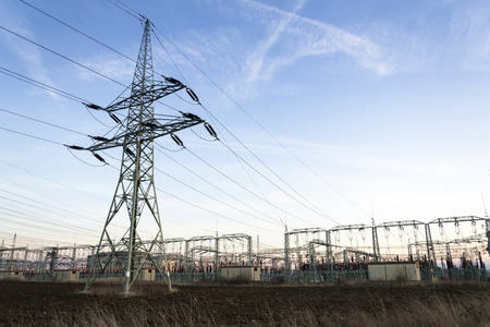 Electricity pylons with distribution power station blue cloudy skyの写真素材