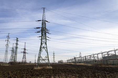 Electricity pylons with distribution power station blue cloudy skyの写真素材
