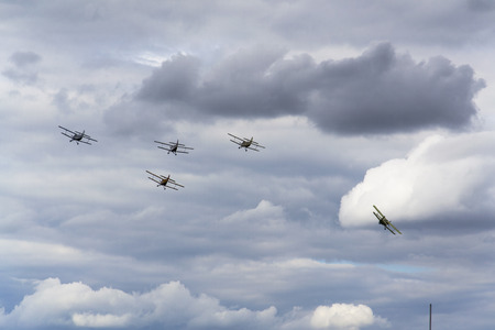 HRADEC KRALOVE, CZECH REPUBLIC - SEPTEMBER 5: Group of Antonov An-2 biplanes flying on September 5, 2015 in Hradec Kralove, Czech republic.のeditorial素材