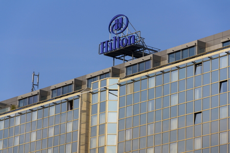 PRAGUE, CZECH REPUBLIC - MARCH 31: Hilton hotels and resorts logo on the building of Hilton Prague hotel on March 31, 2016 in Prague, Czech republic.のeditorial素材