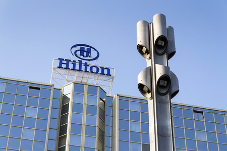 PRAGUE, CZECH REPUBLIC - MARCH 31: Hilton hotels and resorts logo on the building of Hilton Prague hotel on March 31, 2016 in Prague, Czech republic.のeditorial素材