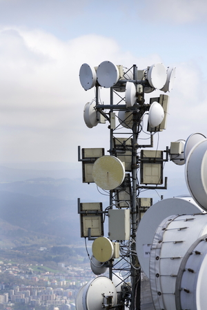 Bunch of transmitters and aerials on the telecommunication towerの写真素材
