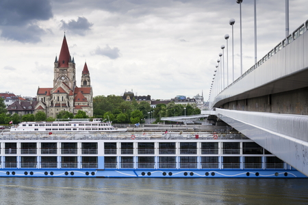 VIENNA, AUSTRIA - MAY 7: Cruise ship on Danube with St. Francis of Assisi Church on Mexikoplatz on 7 May 2012 in Vienna, Austria.のeditorial素材