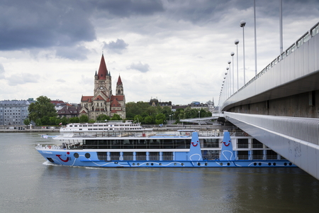 VIENNA, AUSTRIA - MAY 7: Cruise ship on Danube with St. Francis of Assisi Church on Mexikoplatz on 7 May 2012 in Vienna, Austria.のeditorial素材