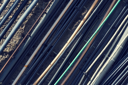 Filtered vintage bunch of data cables outside mounted on wallの写真素材
