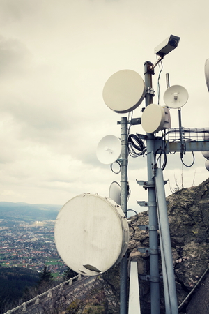Filtered security camera with transmitters and aerials on telecommunication towerの写真素材
