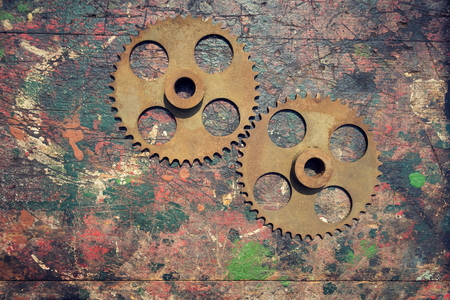 Filtered picture of cogwheels on a colorful wooden backgroundの写真素材