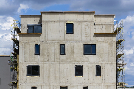 Horizontal photo of house apartment construction site with scaffoldingの写真素材