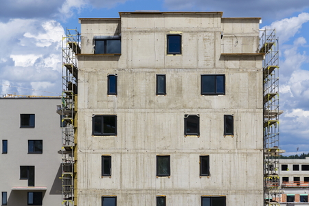 Horizontal photo of house apartment construction site with scaffoldingの写真素材