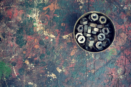 Filtered nuts in a tin can on colorful wooden backgroundの写真素材