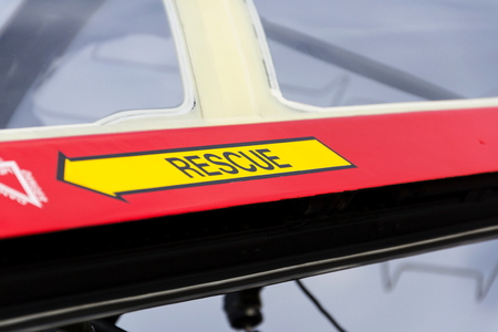 Yellow emergency rescue arrow sign on red military airplane jetの写真素材