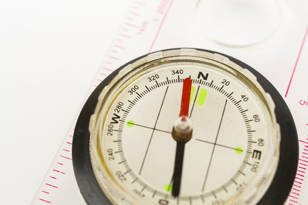 Detail shot of a glass compass on white backgroundの写真素材
