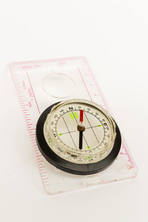 Detail shot of a glass compass on white backgroundの写真素材