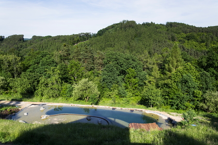 Natural swimming pond purifying water without chemicals through filters and plantsの写真素材