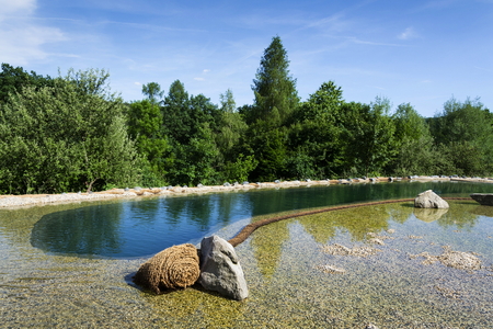 Natural swimming pond purifying water without chemicals through filters and plantsの写真素材