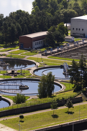 Men checking water storage tanks at sewage treatment plantの写真素材