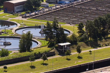 Men checking water storage tanks at sewage treatment plantの写真素材