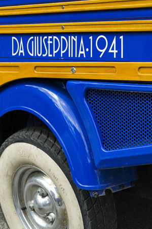LIVIGNO, ITALY - AUGUST 1: Limited edition model of three-wheeled vehicle Piaggio Ape Calessino stands on street on 1 August 2016 in Livigno, Italy.のeditorial素材