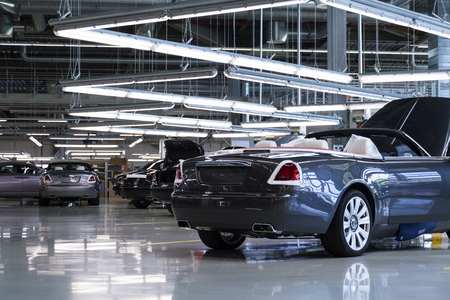 WESTHAMPNETT, UNITED KINGDOM - AUGUST 11: Rolls-Royce cars stand on production line in Goodwood factory on August 11, 2016 in Westhampnett, United Kingdom. Rolls-Royce skips Paris Motor Show.のeditorial素材