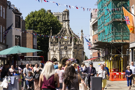 CHICHESTER, UNITED KINGDOM - AUGUST 12: People walk on street in front of the Chichester Cross on August 12, 2016 in Chichester, United Kingdom.のeditorial素材