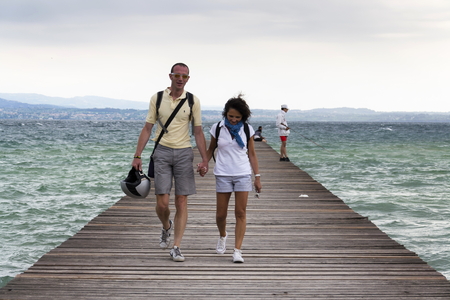 SIRMIONE, ITALY - JULY 31: People on wooden pier on Lago di Garda on 31 July 2016 in Sirmione, Italy.のeditorial素材