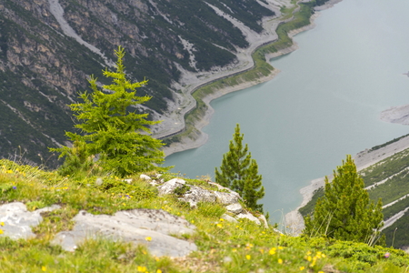 Car tunnel on bank of Livigno Lake in Alps, Italyの写真素材