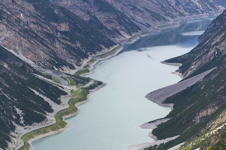 Car tunnel on bank of Livigno Lake in Alps, Italyの写真素材