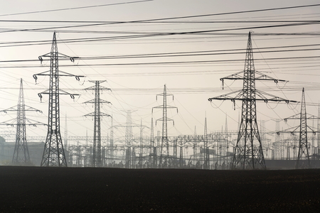 Electricity pylons leading from distribution power station の写真素材