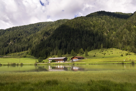 Lake Pillersee with farmhouse in Sankt Ulrich am Pillersee, Austriaの写真素材