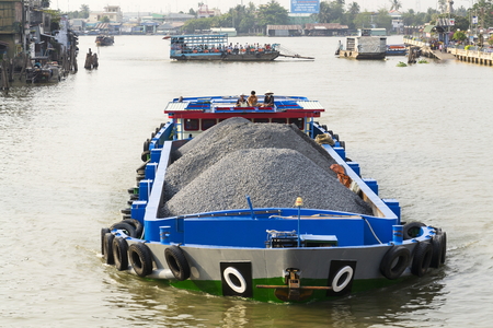 MY THO, VIETNAM - FEBRUARY 13: Boat with stones floating on the Mekong on February 13, 2012 in My Tho, Vietnam.のeditorial素材