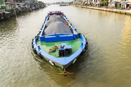 MY THO, VIETNAM - FEBRUARY 13: Boat with stones floating on the Mekong on February 13, 2012 in My Tho, Vietnam.のeditorial素材